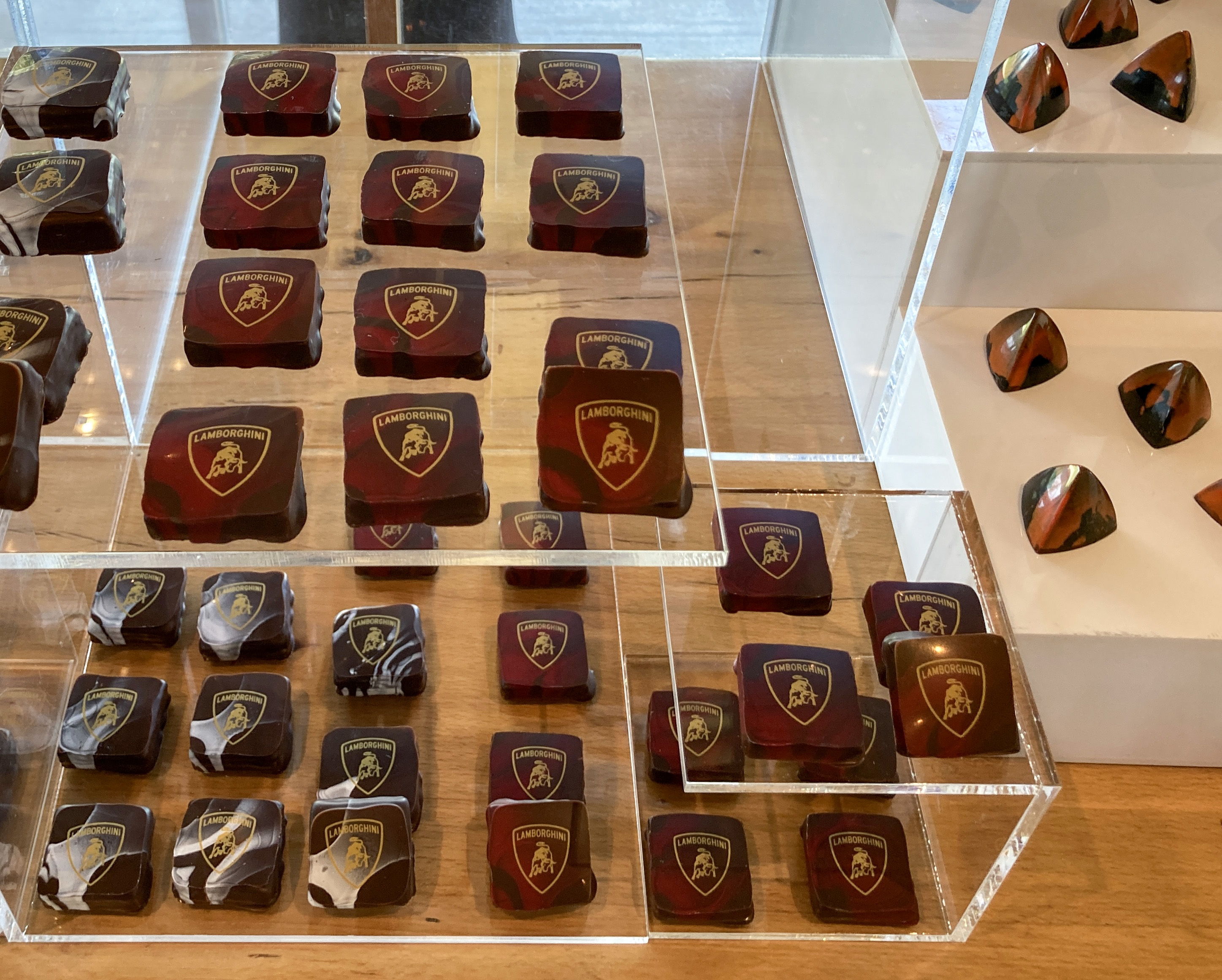 Close view of custom-logo chocolates on the Lamborghini event display