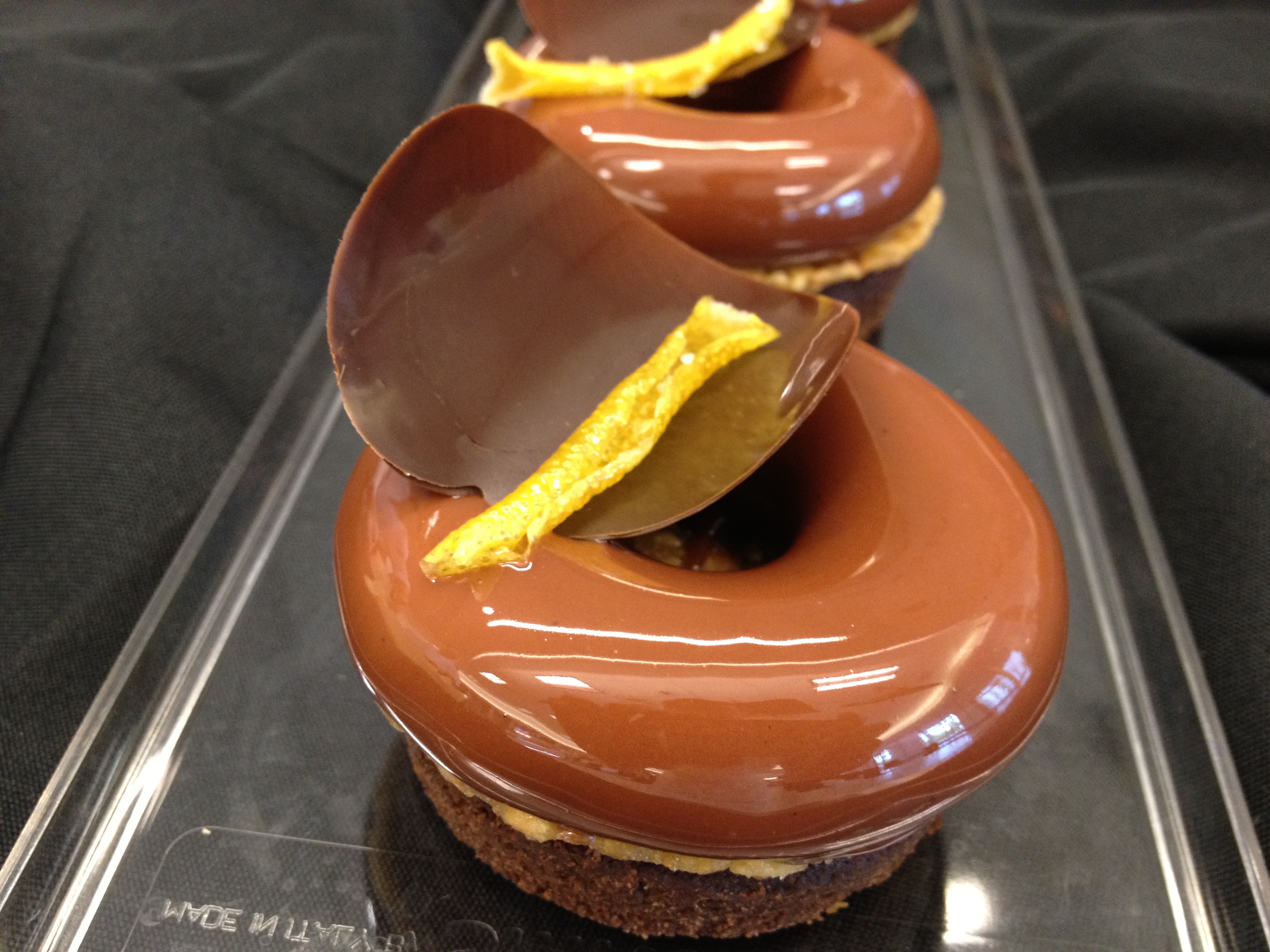 Chocolate petits gâteaux with curved chocolate decorations