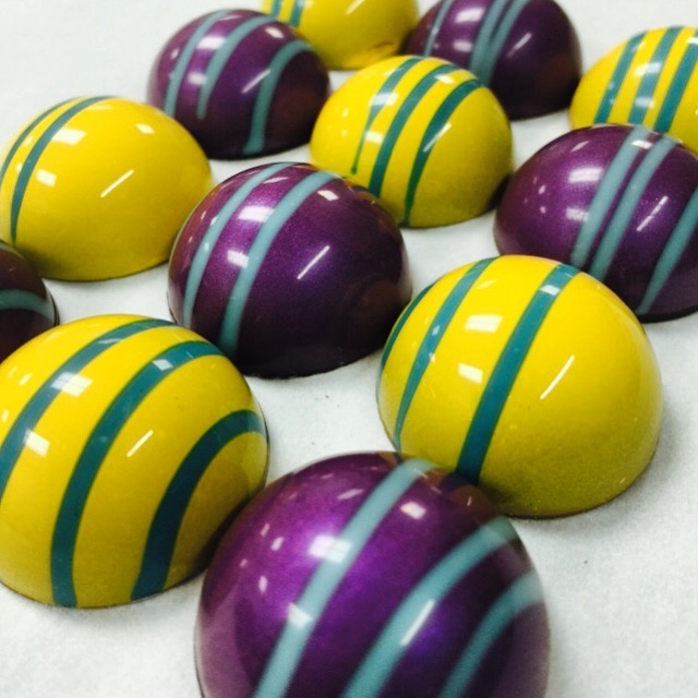 Bright yellow and purple custom-color bonbons made for Thompson Hotel Miami Beach